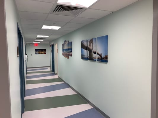 Brightly lit hallway with artwork on walls