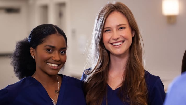 Two smiling staff members in a care facility