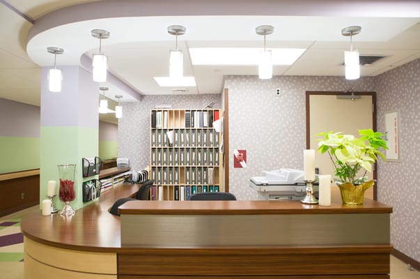 Reception area with a modern desk and lighting