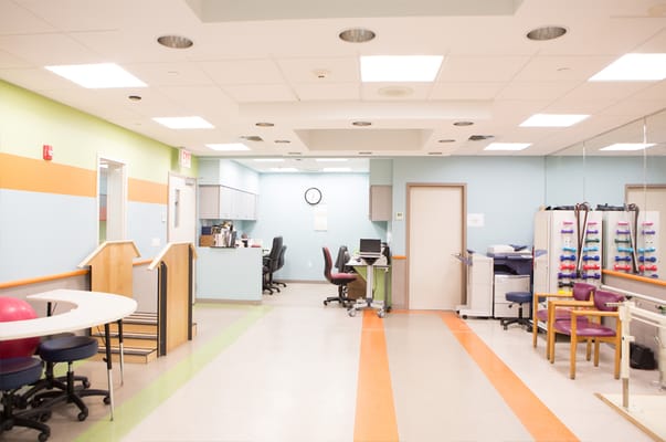 Bright therapy room with equipment and seating