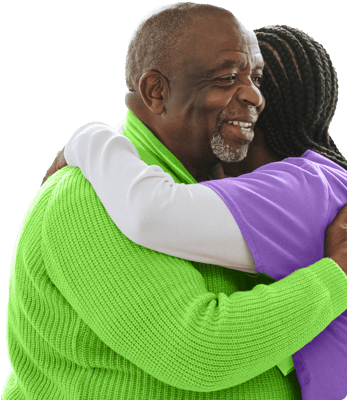 A resident and staff member sharing a warm hug