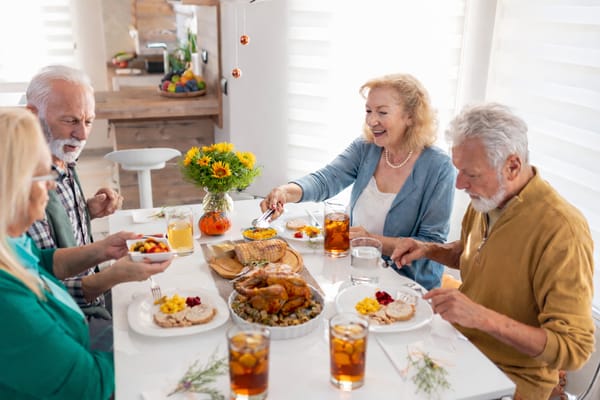 Residents enjoying a meal together at a dining table