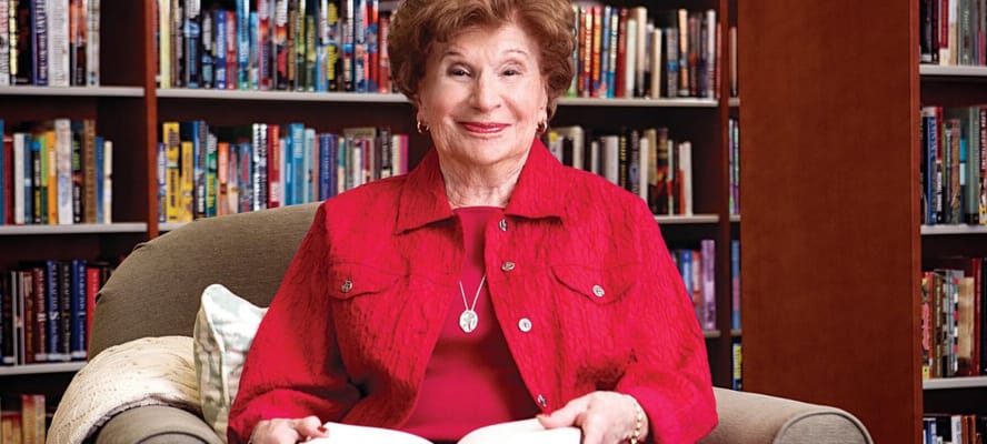 Resident reading in a cozy library setting