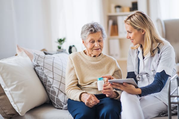 A nurse consulting with a senior resident at home