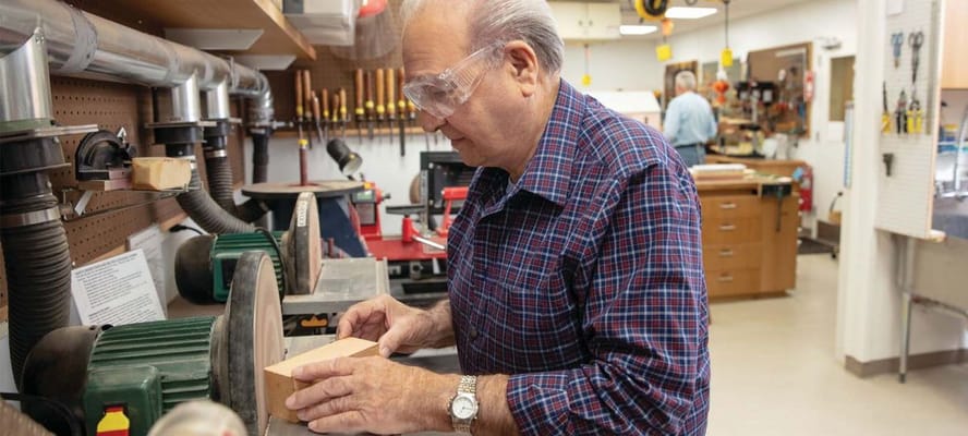 Senior resident engaged in woodworking activity