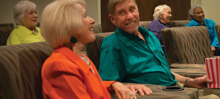 Residents enjoying a movie night in a common area