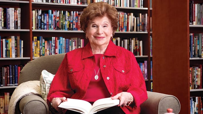 Resident reading in a cozy library setting