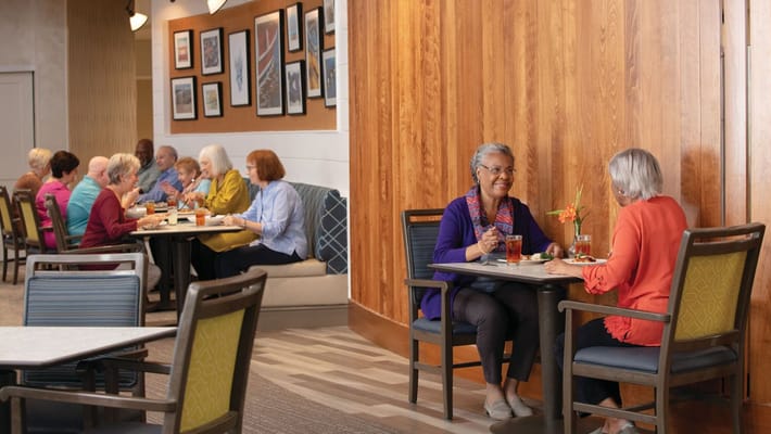 Residents dining and socializing in a communal space