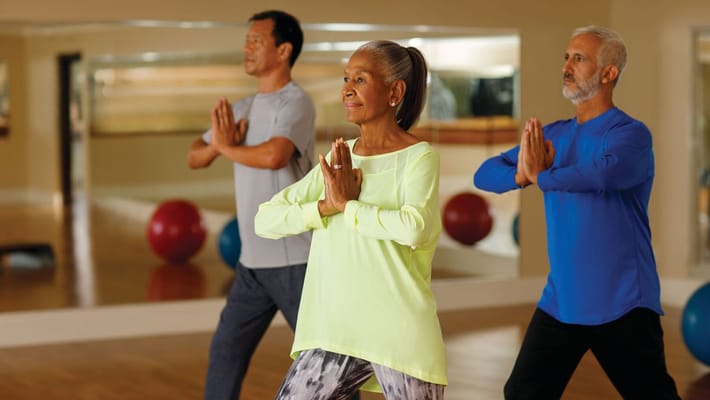 Residents participating in a wellness class in a bright studio
