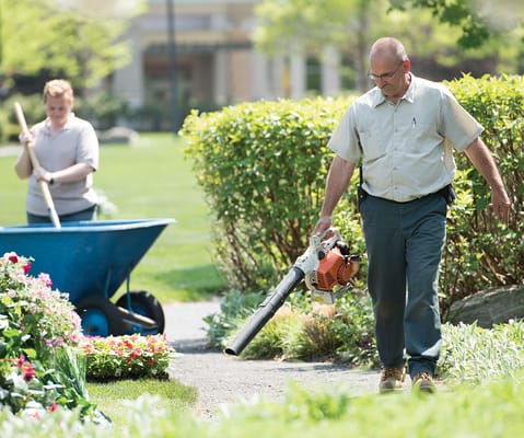 Staff maintaining the gardens in the facility's outdoor space
