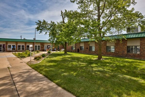 Courtyard with green grass and trees at the nursing center