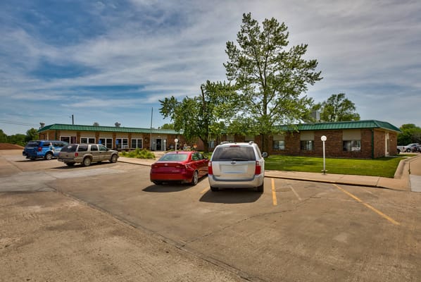 Exterior view of Cameron Nursing Center with vehicles in the parking lot
