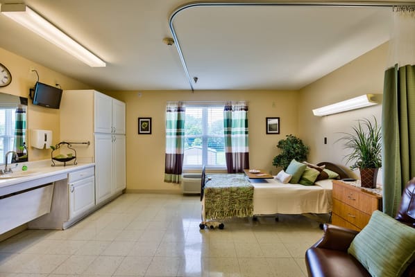 Bright resident room with a bed and windows