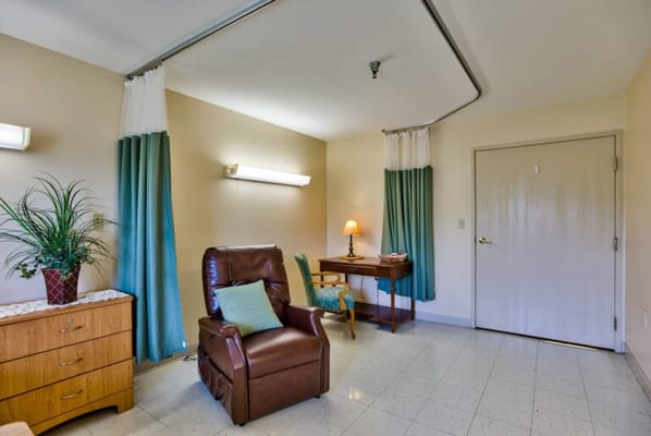 Cozy interior of a resident room with a chair and lamp