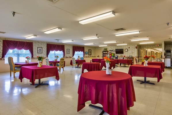 Bright common area with tables and flowers