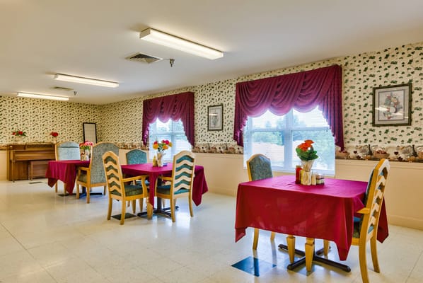Dining area with red tables and floral decorations