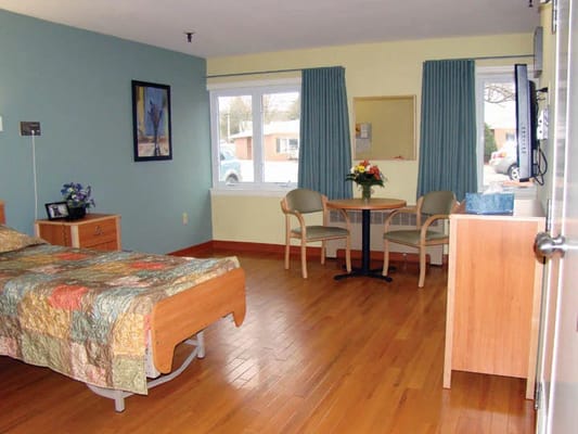 Private resident room with a bed and seating area