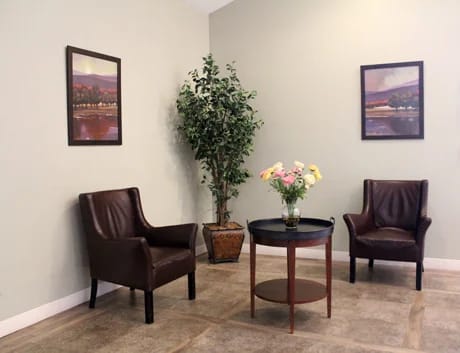Cozy common area with chairs and a flower arrangement