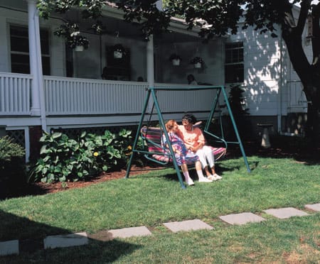 Two residents enjoying a swing in the garden
