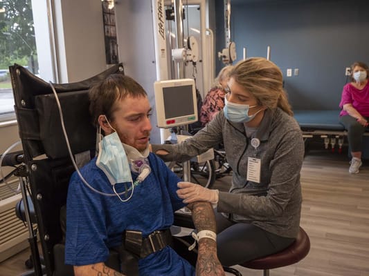 Therapist assisting a resident during rehabilitation