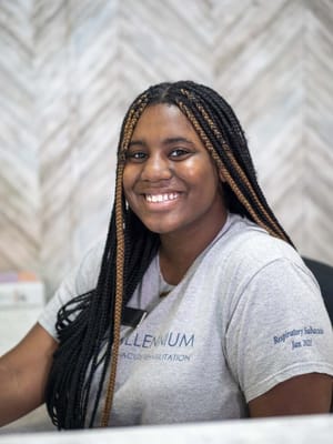 Staff member at the reception desk smiling