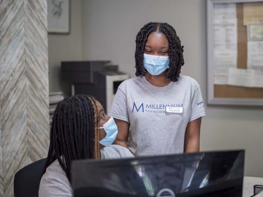 Staff assisting each other at a reception desk