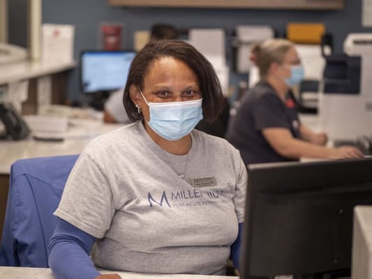 Staff member at the reception desk wearing a mask