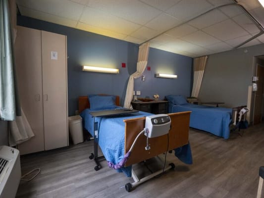 Private resident room with two beds and amenities