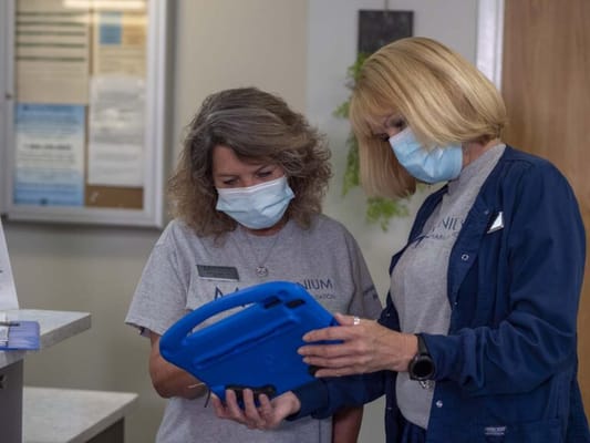 Two staff members reviewing information in an interior setting