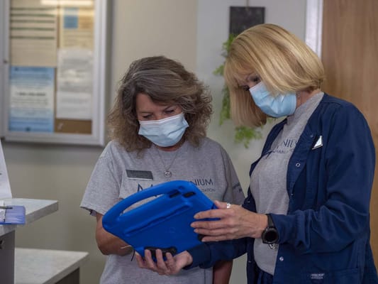 Two staff members reviewing information in an interior setting