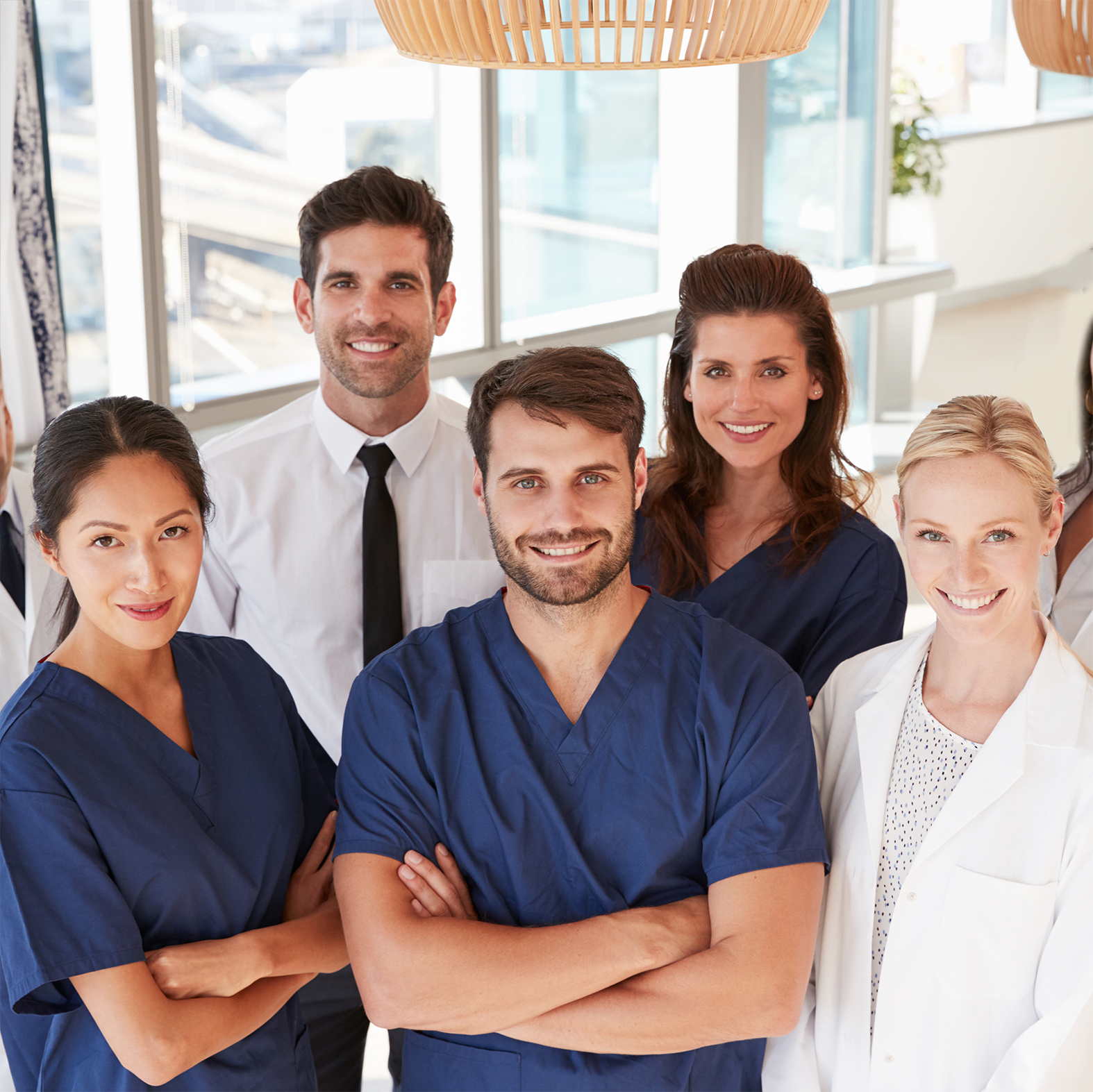 Staff members posing in a bright common area