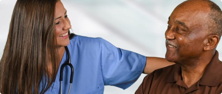 A nurse interacting with a senior resident in a caring manner