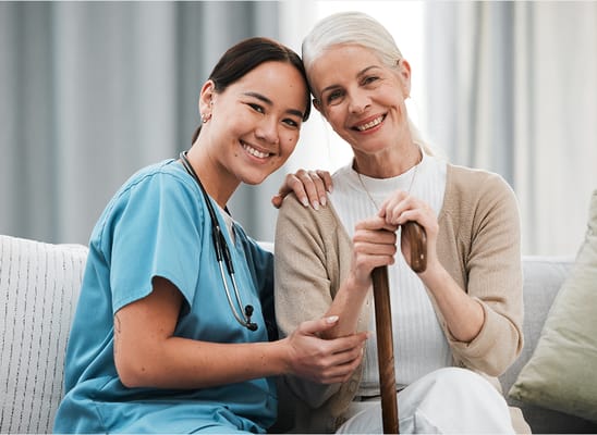 Healthcare worker smiling with a resident