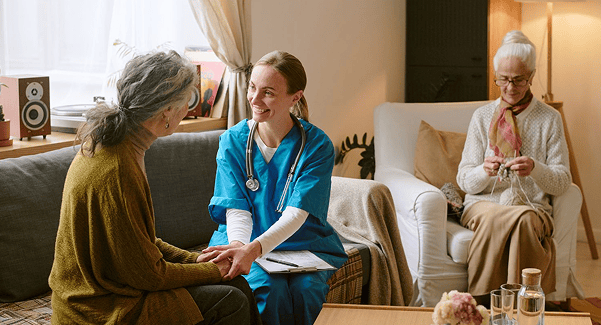 Nurse interacting with a resident in a cozy common area