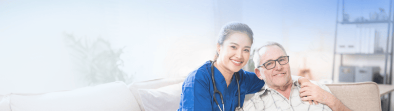 Staff member smiling with a resident in a cozy setting