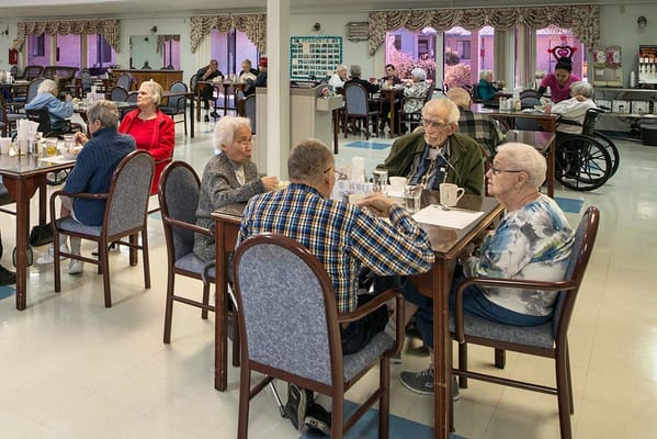 Residents enjoying conversation in the dining room