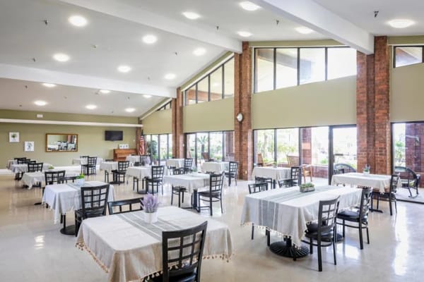 Bright dining room with tables set for meals