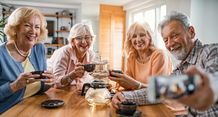Residents enjoying tea and snacks at a common area