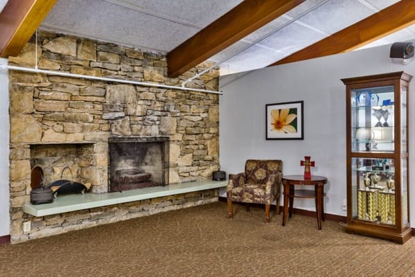 Cozy fireplace and seating area in the facility common room