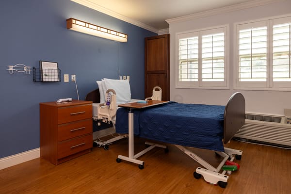 Private resident room with bed and chest of drawers