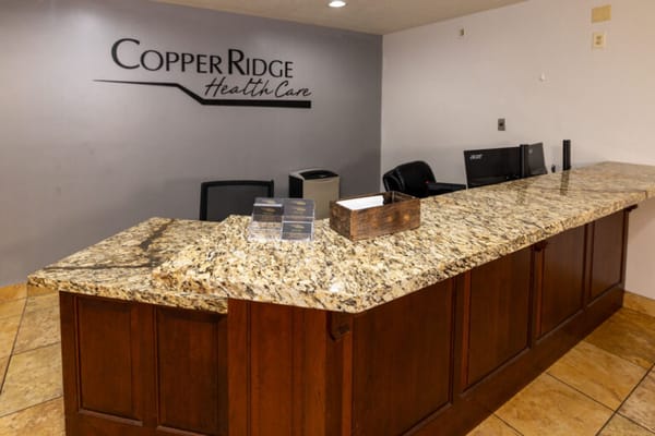 Reception area with granite counter and facility branding