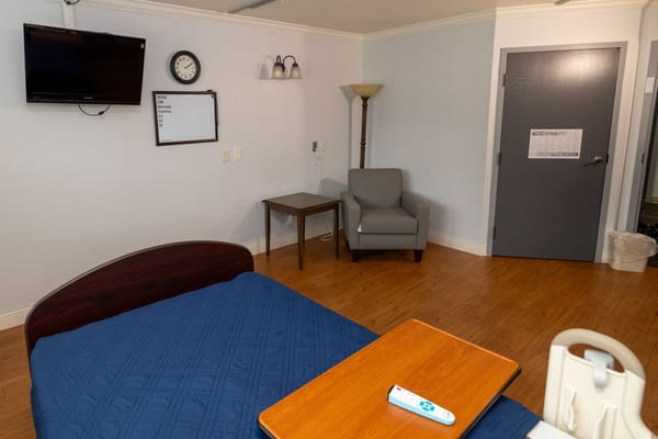 Interior view of a resident room with basic furnishings