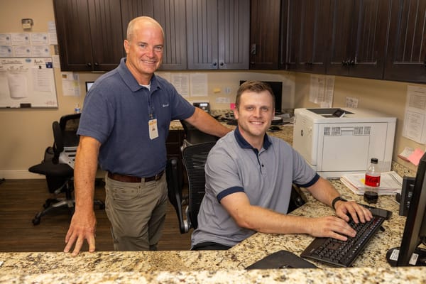 Staff members at a front desk in an office