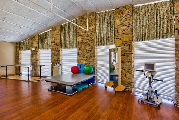 Rehabilitation room with exercise equipment and therapy balls