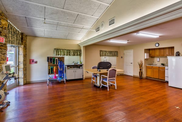 Interior view of a common activity room with kitchen