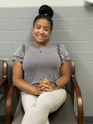 Staff member smiling in a facility common area