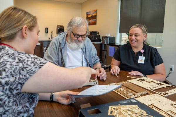 Residents and staff engaging in a craft activity