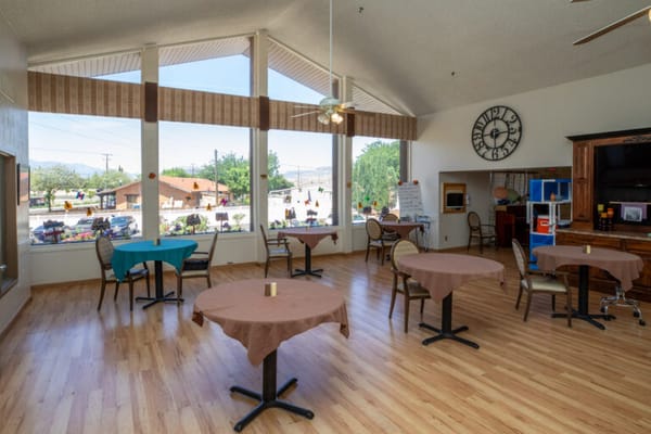 Bright common area with tables and large windows
