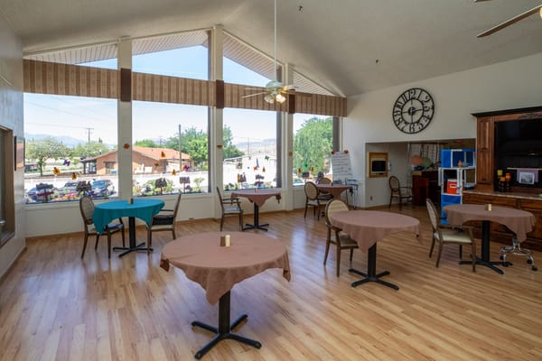 Bright common area with tables and large windows