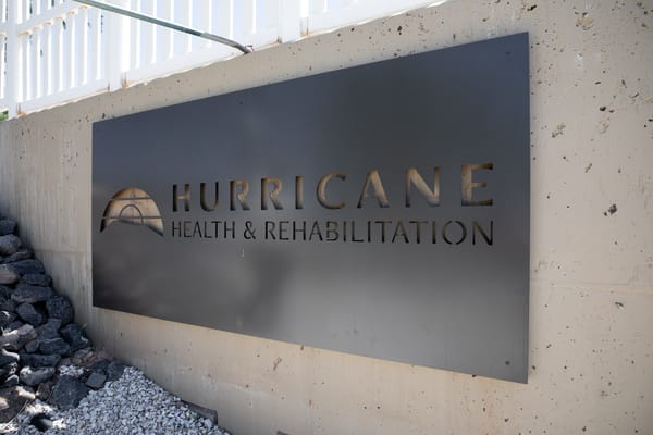 Facility logo mounted on outdoor wall